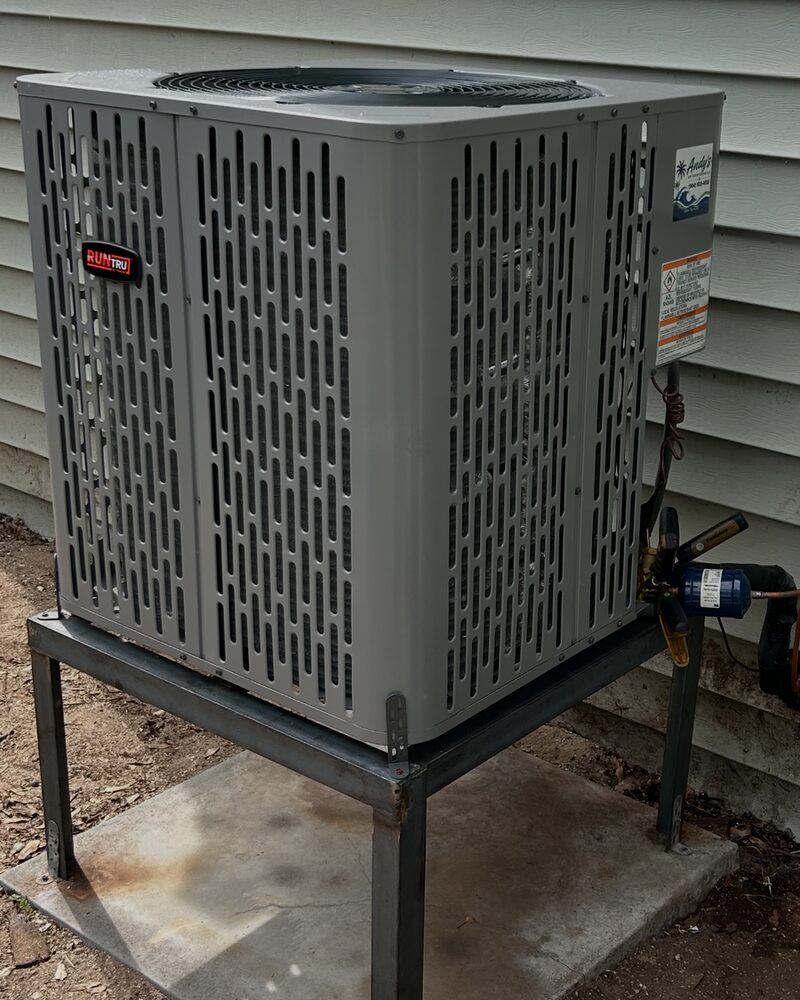 New condenser raised on a steel stand with an Andy's Air label
